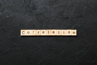 correlation word written on wood block. correlation text on table, concept.