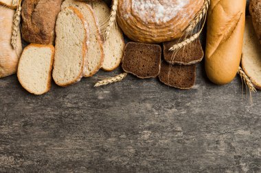Ev yapımı doğal ekmek. Arka plan olarak farklı taze ekmek türleri, kopya alanı ile üst görünüm.
