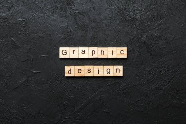 Tahta blokta yazılı grafik tasarım kelimesi. Deksing, konsept için çimento üzerinde grafik tasarım metni.