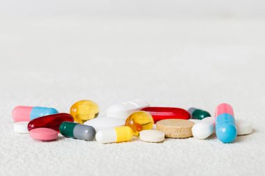 Many different colorful medication and pills perspective view. Set of many pills on colored background.