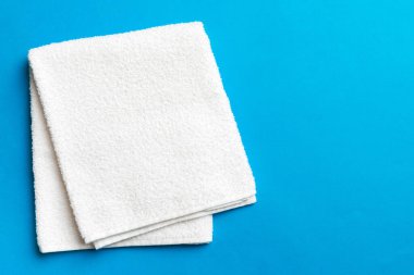 Renkli arkaplanda kopyalama alanı olan beyaz havluların üst görünümü.