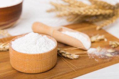 Tahta kasede buğday unu ve renkli arka planda buğday dikenleri. dünya buğday krizi.