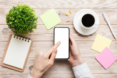 Mesajınız veya bilgi içeriğiniz için boş bir kopya ekranı olan akıllı telefonları tutan kadın ellerinin üst görünümü. üst görünümde telefon beyaz ekranı kullanan kadın eli.