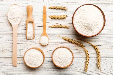 Tahta kasede buğday unu ve renkli arka planda buğday dikenleri. dünya buğday krizi.