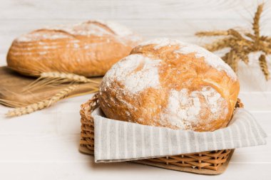 Doğal arka plana karşı sepette taze pişmiş ekmek. Perspektif görünümü ekmek kopyalama alanı.