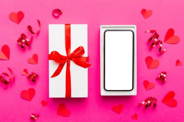 Opened gift box with ribbon and phone on color background, top view. Blank open box packaging mockup , Template for your design - branding mockup.