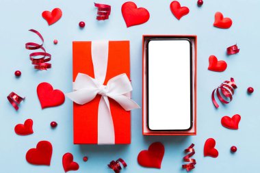 Opened gift box with ribbon and phone on color background, top view. Blank open box packaging mockup , Template for your design - branding mockup.