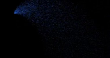 Flying blue particles on a black background in the form of a sparkling sparkler or comet. Fireworks concept.