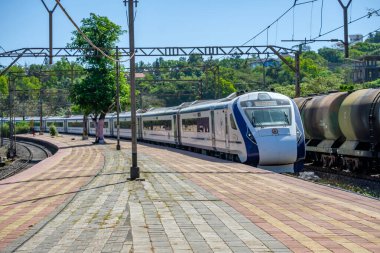 Khandala, India - April 02 2023: The Solapur Mumbai Vande Bharat Express heading towards Mumbai, at Khandala India. clipart