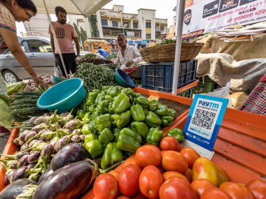 Pune, Hindistan - 30 Ekim 2023: Pune Hindistan 'daki bir sebze tezgahında sebzeler arasında yapılan ödemeler için bir QR kod tarayıcısı yerleştirildi.