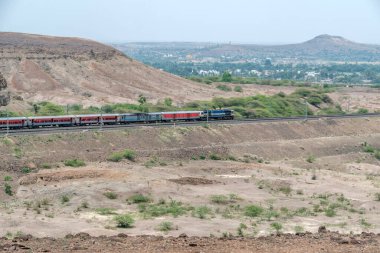 Pune, Hindistan - Haziran 01 2024: WDP4D dizel lokomotif Pune Hindistan yakınlarındaki bir yolcu trenini taşıyor.