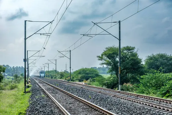 stock image Pune, India - June 23 2024: The Vande Bharat Express heading towards Mumbai during the monsoon season near Pune India. Monsoon is the annual rainy season in India from June to September.