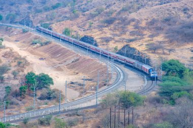 Pune, Hindistan - 01 Mart 2025: WDP4D dizel lokomotif Pune Hindistan yakınlarındaki bir yolcu trenini taşıyor.