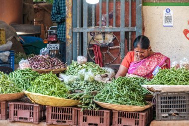 Pune, Hindistan - 09 Mart 2025: Pune India 'daki Mandai pazarında kadın satıcı. Pune şehrinin en büyük perakende sebze pazarı ve 1886 'dan kalma ikonik bir binada bulunuyor..