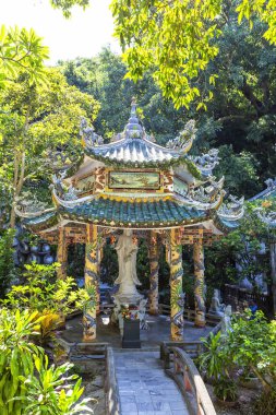 Vietnam 'daki Mermer Dağları' nın yemyeşil yeşillikleri arasında, Merhametin Bodhisattva 'sı Guan Yin' in heykelini barındıran süslü bir pavyon.