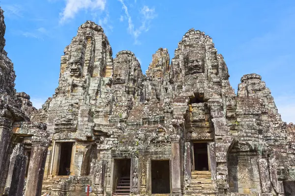Angkor Thom 'daki Bayon Tapınağı' nın kulelerini süsleyen birden fazla oyulmuş yüz.