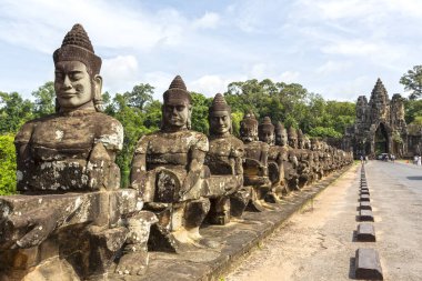 Antik heykeller Angkor Thom 'un Güney Kapısı' na giden köprü hizasında.