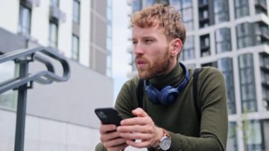 Merdivenlerde oturan kulaklık takan yakışıklı bir adam yaz günü modern şehirde açık havada dans ederek cep telefonu uygulamasından bir şarkı seçiyor. Adam eğleniyor, şehir sokaklarında dinleniyor. İnsanlar ve müzik konsepti