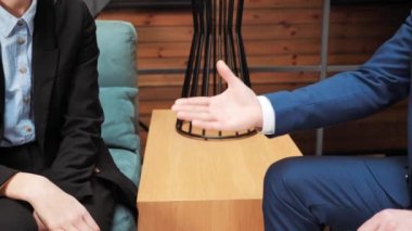Close up male hands multiethnic caucasian and american business people men shaking successful corporate partnership deal, making handshake in office, congratulating after signing contract documents