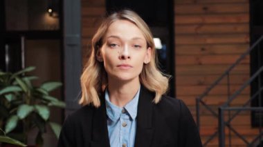 Successful Businesswoman in Stylish Suit and Deep Blue Eyes Looking at Camera, Standing in Modern Loft Office Working on Financial, Business and Marketing Projects. Portrait of Beautiful Ceo Manager