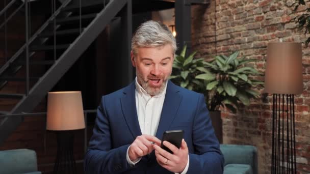 Joyful Wonderstruck Adult Businessman Celebrating Mobile Success Making Winner Yes — Vídeo de stock