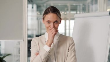 Close up female face portrait female office worker woman beautiful young girl lady looking at camera makes gesture silence sign pretends to close zip up mouth keep secret information silent