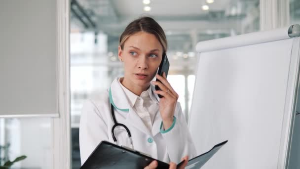 Young Professional Female Doctor Lab Coat Stethoscope Neck Holding Folder — Video Stock