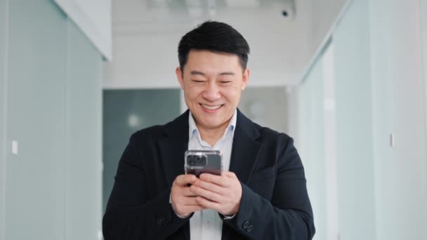 Happy Chinese Businessman Holding Smartphone Using Mobile Application Program Looking — Stok Video
