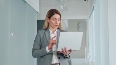 Düşünceli, ciddi, profesyonel kadın ofis çalışanı. İlham verici, arama sorunu çözümleri düşünüyor. Hayal kuruyor, yazı yazma mesajlarını görmezden geliyor, koridorda dizüstü bilgisayarda karar veriyor.
