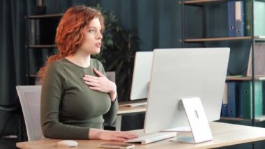 Beautiful sick female office worker having panic attack at workplace. Woman employee having shortness of breath, tired suffering from severe chest pain heartache at work indoor. Breathing problems