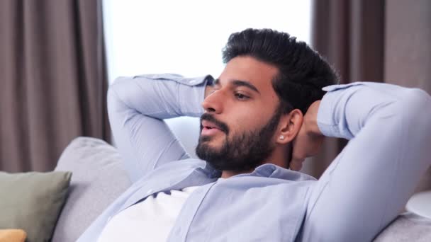 Расслабляющий Красивый Индийский Мужчина Показан Кадре Голове Расслабляясь Удобном Диване — стоковое видео