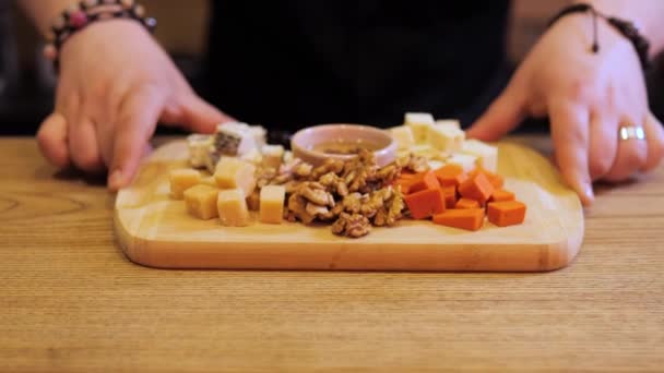 Professional Bartender Places Platter Assorted Cheeses Nuts Honey Bar Cheese — Stock Video