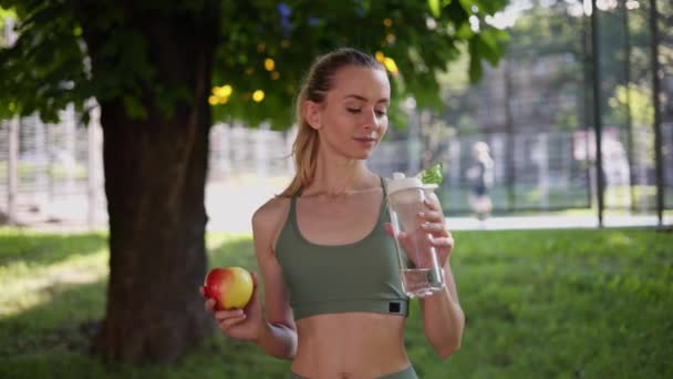 Fit Atletyczny Stonowany Szczupła Dziewczyna Posiada Czerwone Jabłko Świeżą Wodę — Wideo stockowe