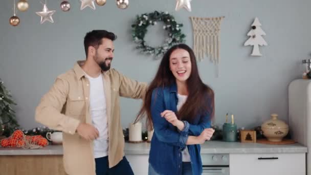 Energetic Young Couple Love Dances Joyfully Christmas Decorated Kitchen Celebrating — Stock Video