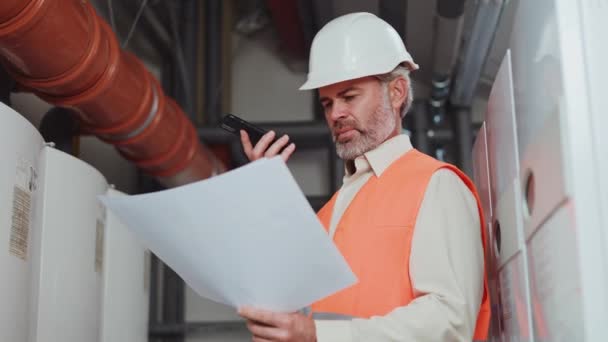 Professional Serious Technician Grey Beard Wearing Uniform Holding Work Plan — Stock Video