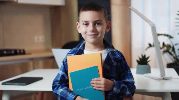 Portrait Smiling Male Child Dressed Checked Shirt Holding Copybooks Indoors — Stock Video