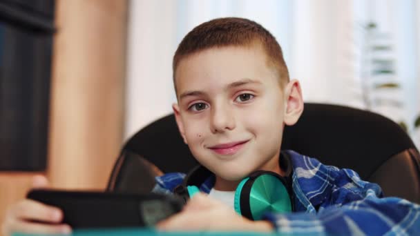 Close Portrait Smiling Caucasian Boy Sitting Comfortable Chair Wireless Headphones — Stock Video