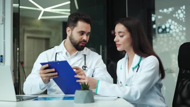 Successful Male Therapist Holding Clipboard Documents While Sitting Female Colleague — Stock Video