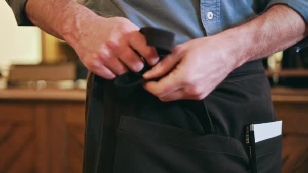 Close Professional Waiter Tying Black Apron Bow Personal Notebook Pen — Stock Video