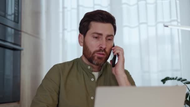 Concerned Man Fancy Hairstyle Picking Smartphone Call While Sitting Desk — Stock Video