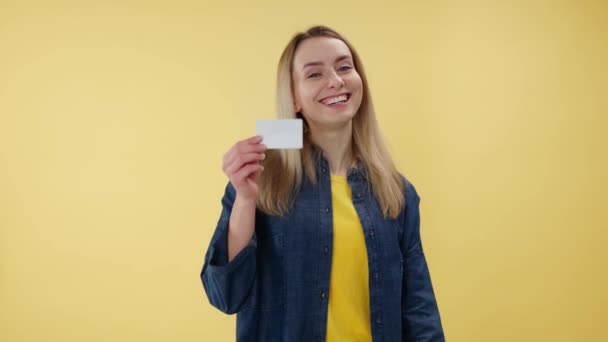 Junge Kaukasische Frau Mit Kreditkarte Während Sie Vor Isoliertem Gelben — Stockvideo