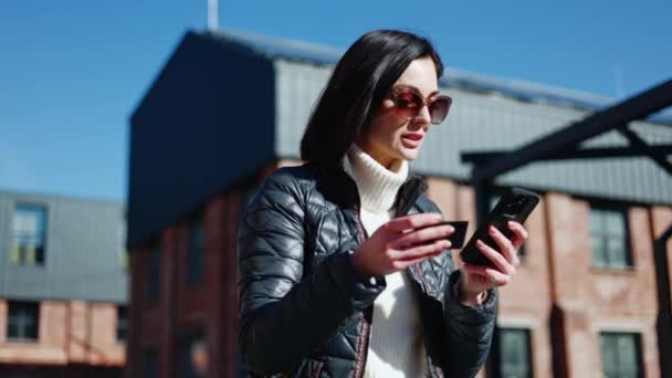 Serious Woman Eyewear Dictating Bank Card Data Phone Speaker Getting — Stock Video