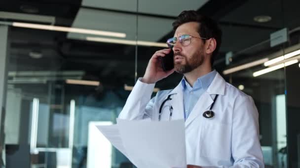 Trabajador Sanitario Masculino Serio Hablando Por Teléfono Mientras Sostiene Los — Vídeo de stock