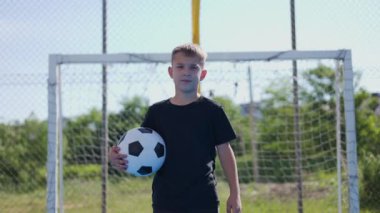 Futbol takımının ciddi kaptanı elinde futbol topuyla stadyumun ortasında yavaşça yürüyor. Karizmatik bir çocuk, şampiyonluk maçında zafere büyük bir tutkuyla güveniyor..