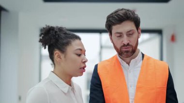 Profesyonel yatırımcı ve mimar ofiste bir planı tartışıyor. Bir iş toplantısında odaklanmış ve ciddi hissediyorlar. Ticari gayrimenkul yatırımlarında uluslararası işbirliği anlaşması.