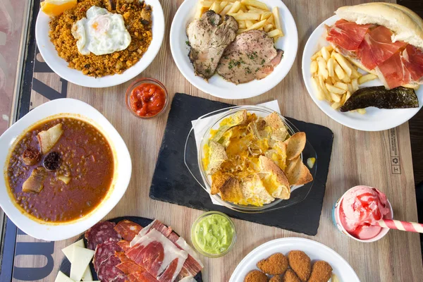 stock image Tapas and beer: typical spanish food shot from above on rustic wooden table