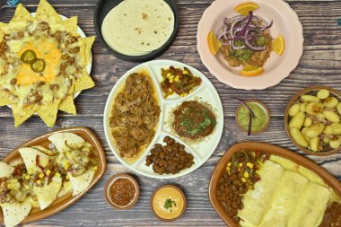 İçinde nacho, taco ve enchilada 'nın da bulunduğu bir masa.