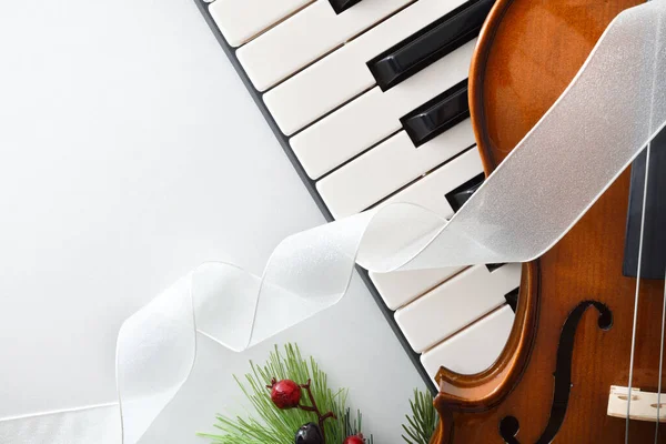 stock image Detail of christmas musical event concept background with piano and violin on white table. Top view.