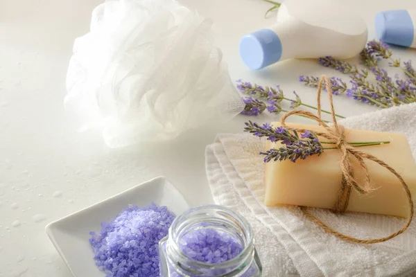 Bath products with lavender extract with elements for personal hygiene on white table. Elevated view. Horizontal composition.