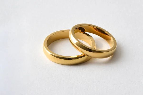 Detail Two Gold Wedding Rings Lying One Other White Isolated — Stock Photo, Image